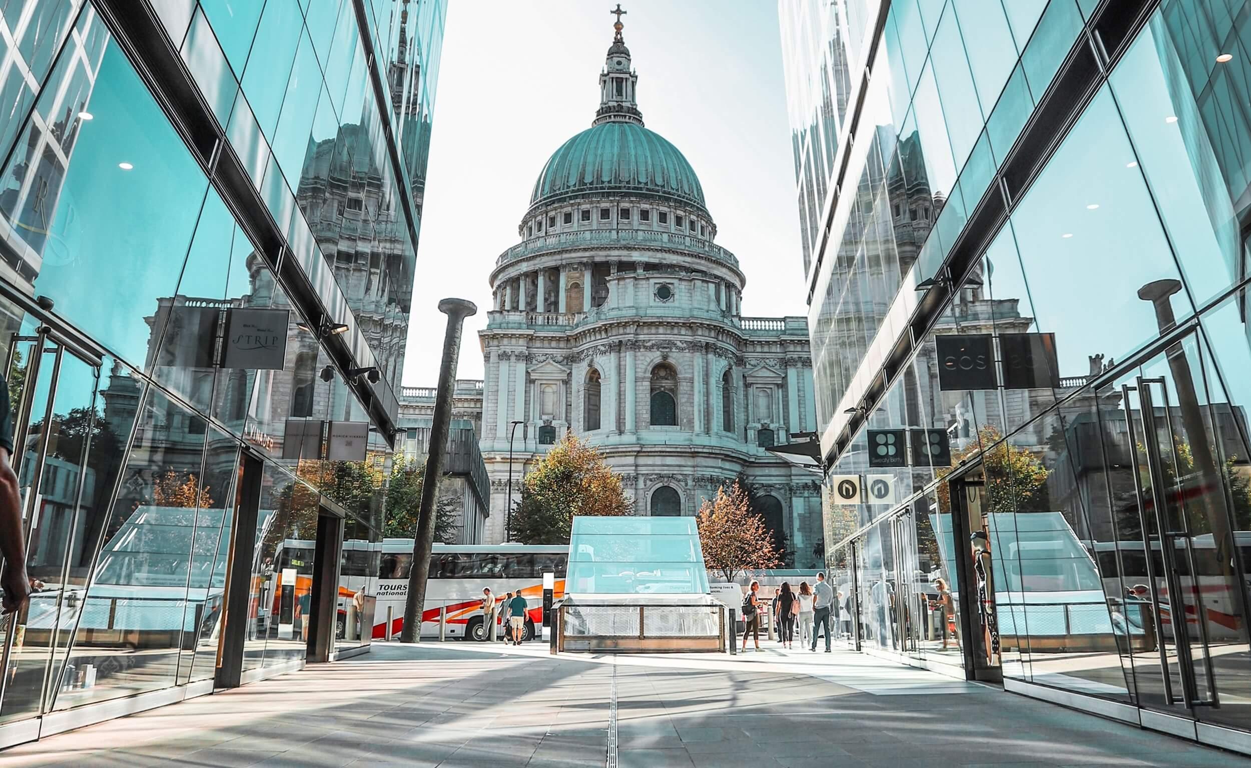 St Paul's Cathedral framed between modern glass office buildings in the City of London.
