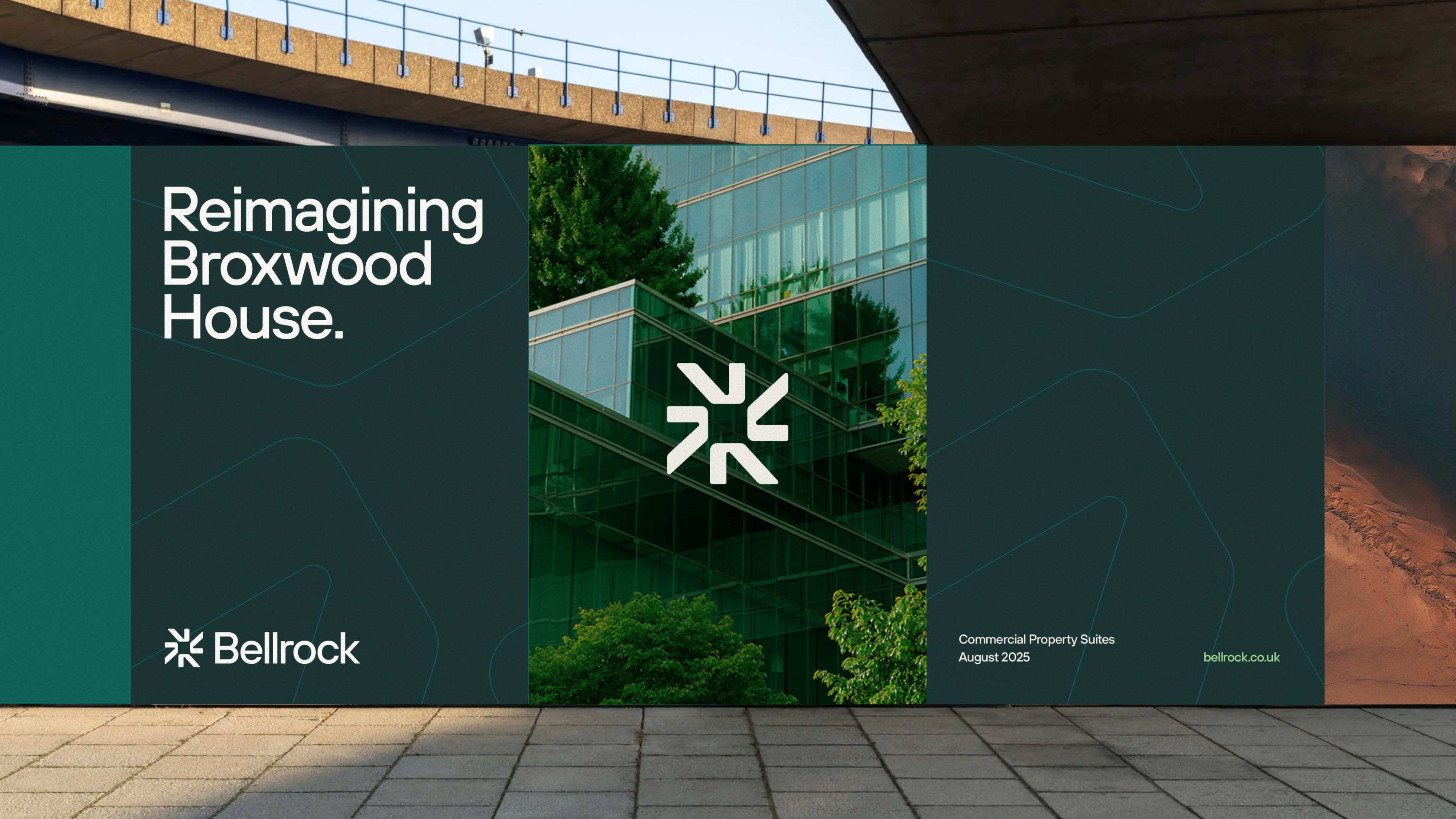 A large outdoor banner showing the text “Reimagining Broxwood House,” alongside the Bellrock symbol and a photograph of a modern glass building surrounded by greenery.
