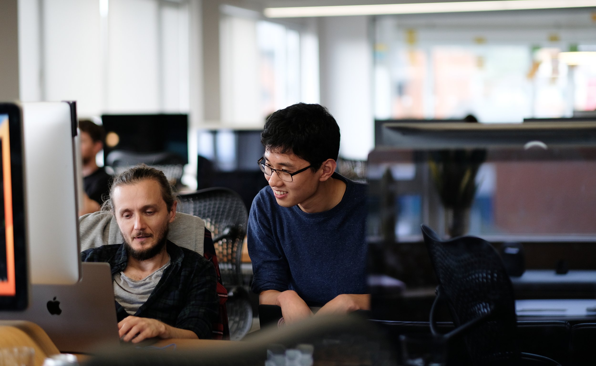 Two people working together in a modern office space