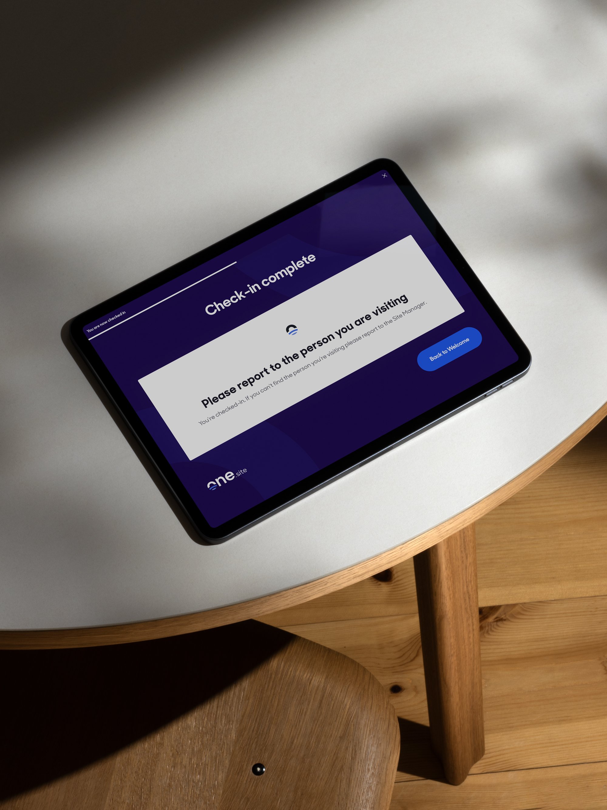 A construction worker being instantly recognised by the One.site facial recognition check-in system at a site entrance.