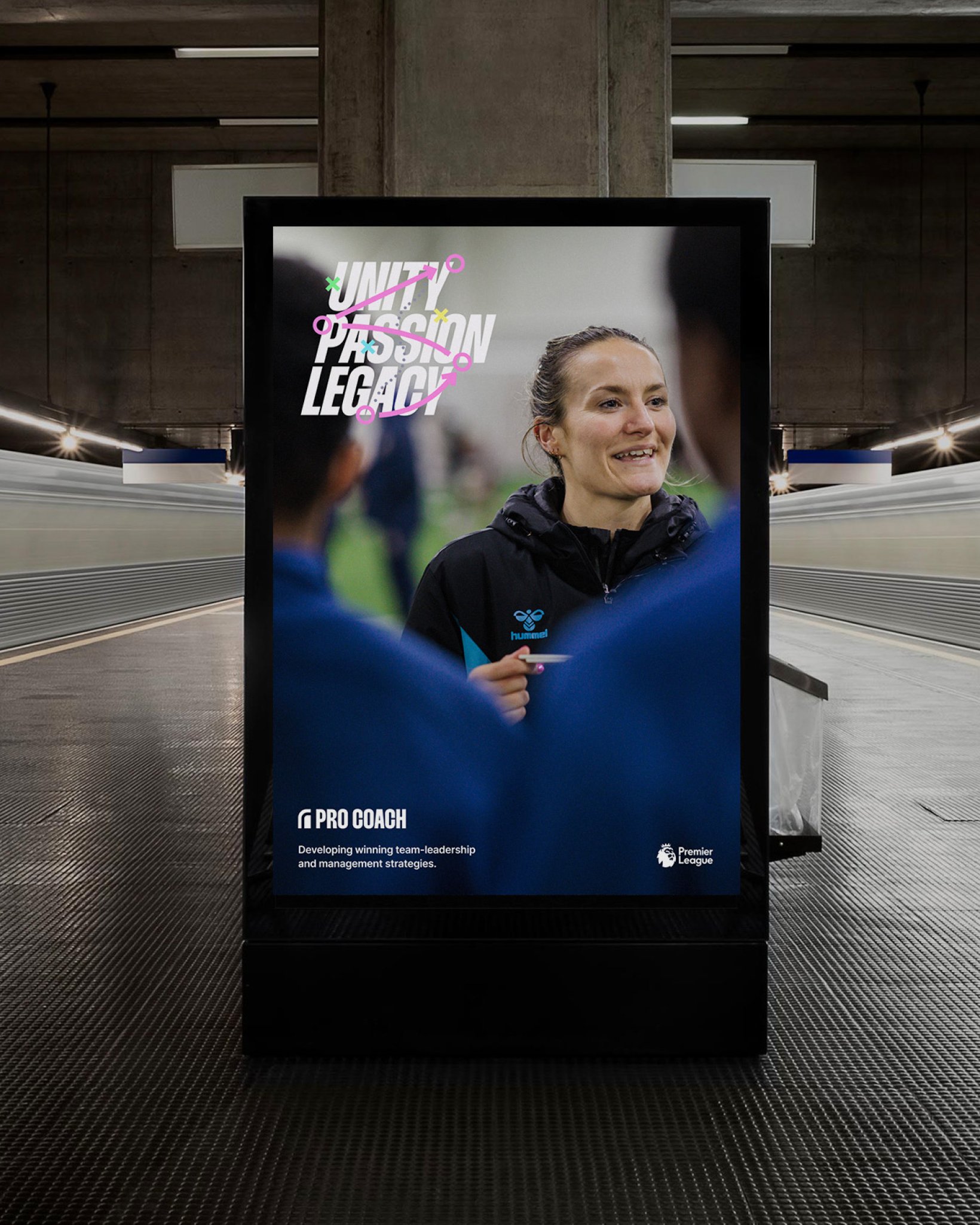 A digital advertising board in an underground station showing a smiling football coach with the headline “Unity Passion Legacy” and branding for Pro Coach and the Premier League.