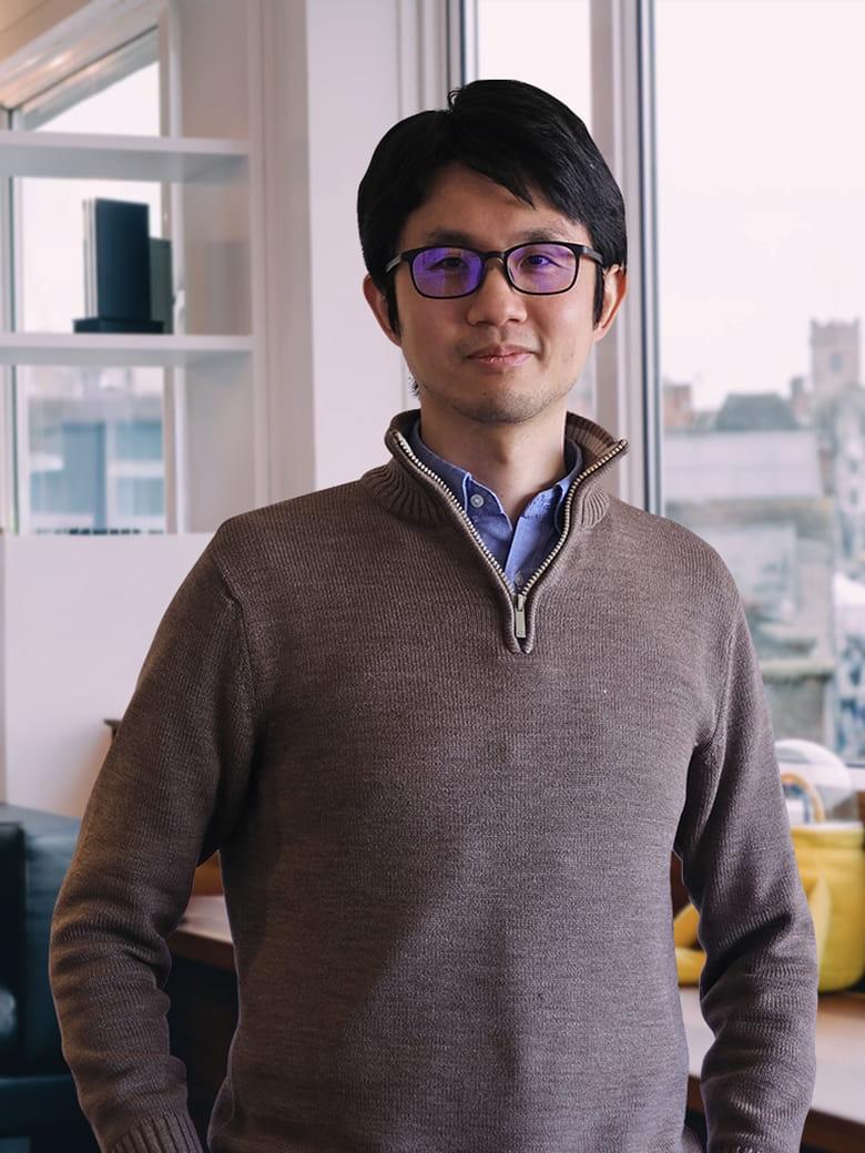 Henry Lo sitting in an office environment